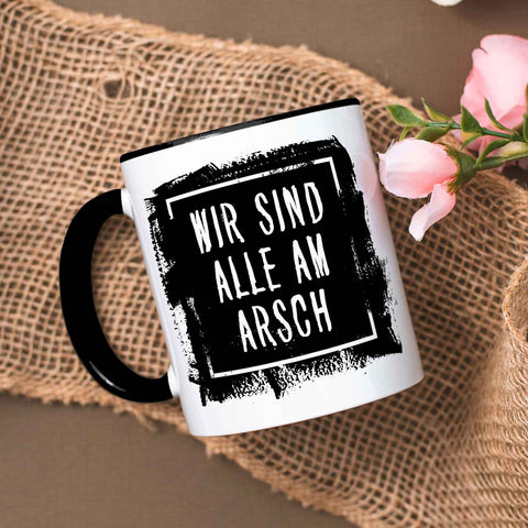 Bedruckte Tasse mit Spruch - "Wir sind alle am Arsch"